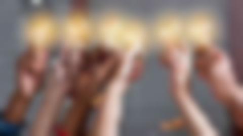 Six hands holding a light bulb each